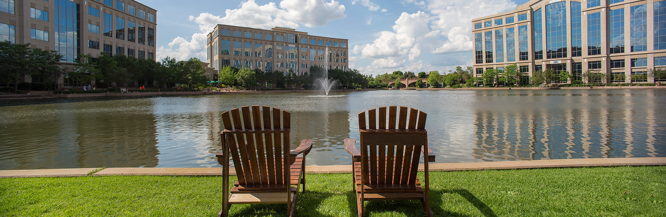 Centennial Lakes buildings with a pond in the middle