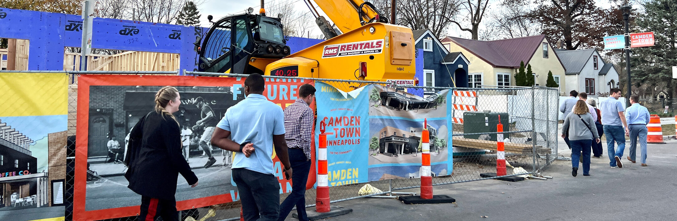 Group of people walking by construction