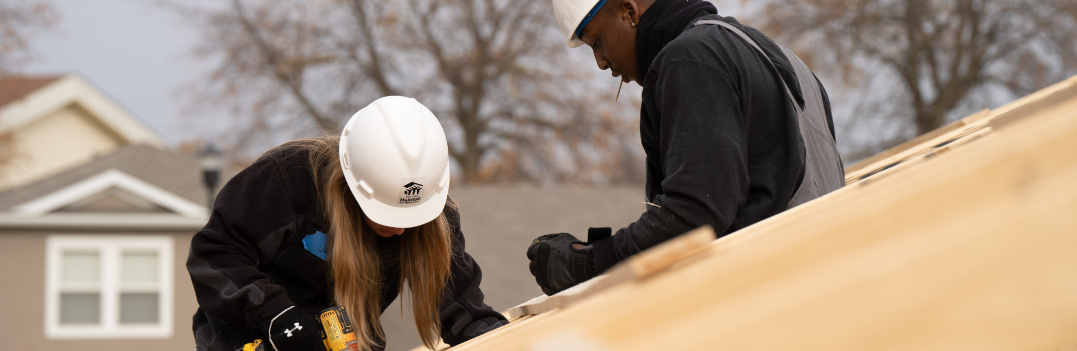 Two people building a house