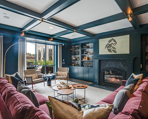 Multi-Family furnished living room space with teal walls and a fireplace