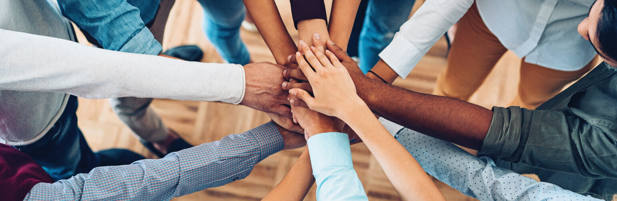 Group of people with their hands on top of each other