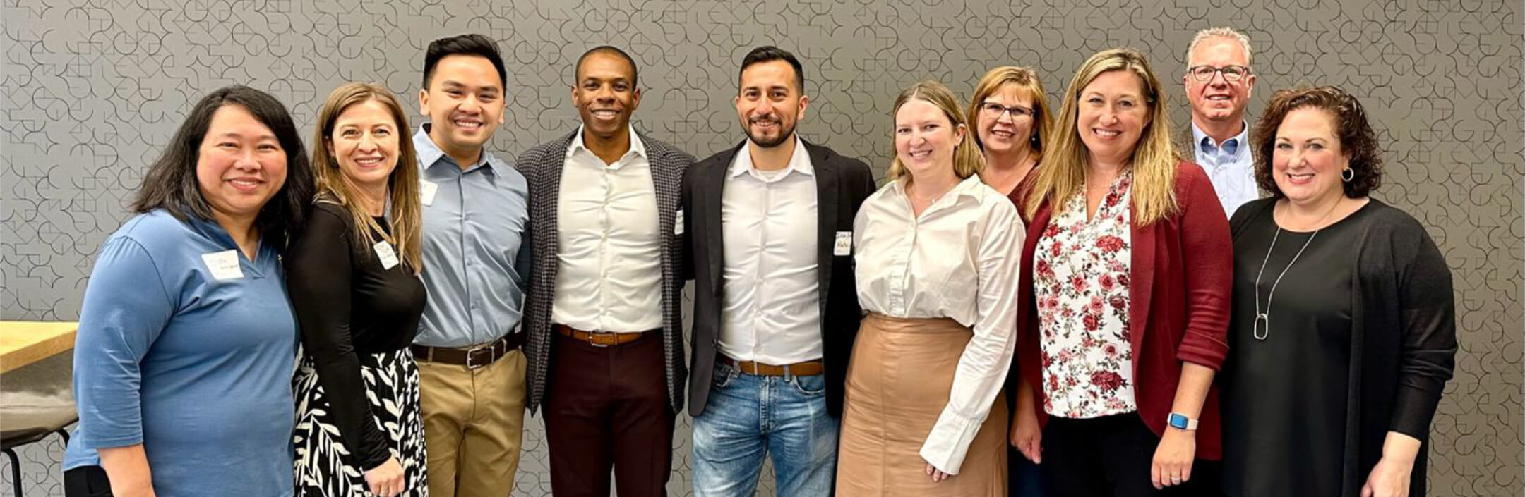 Group of people posing for a photo with name tags on