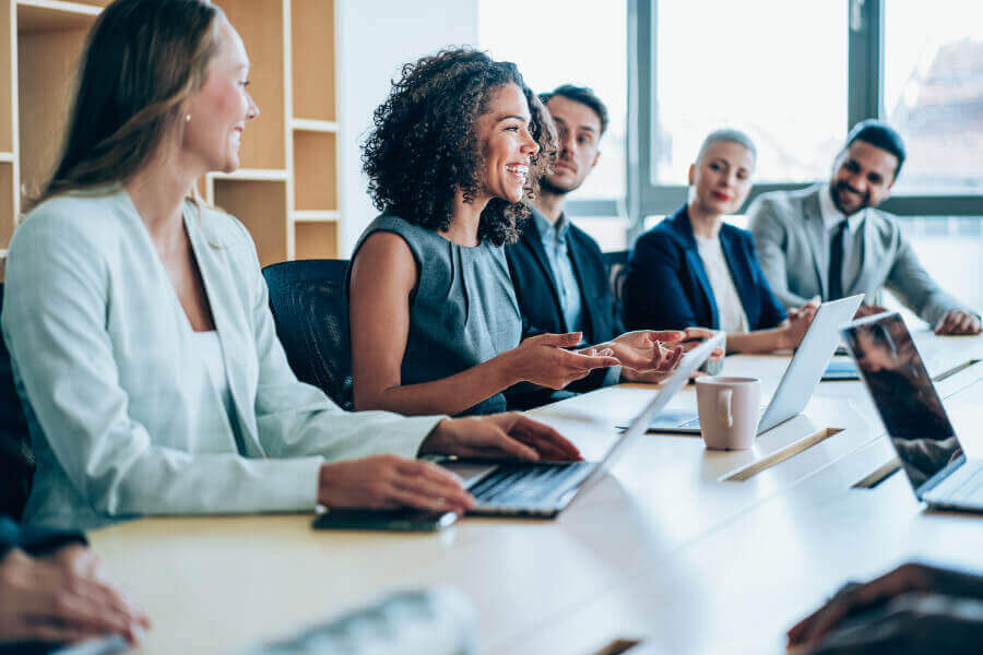 Group of men and women sitting in a meeting