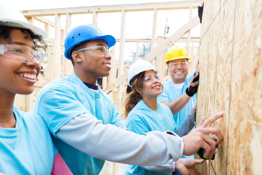 Group of people working on a house