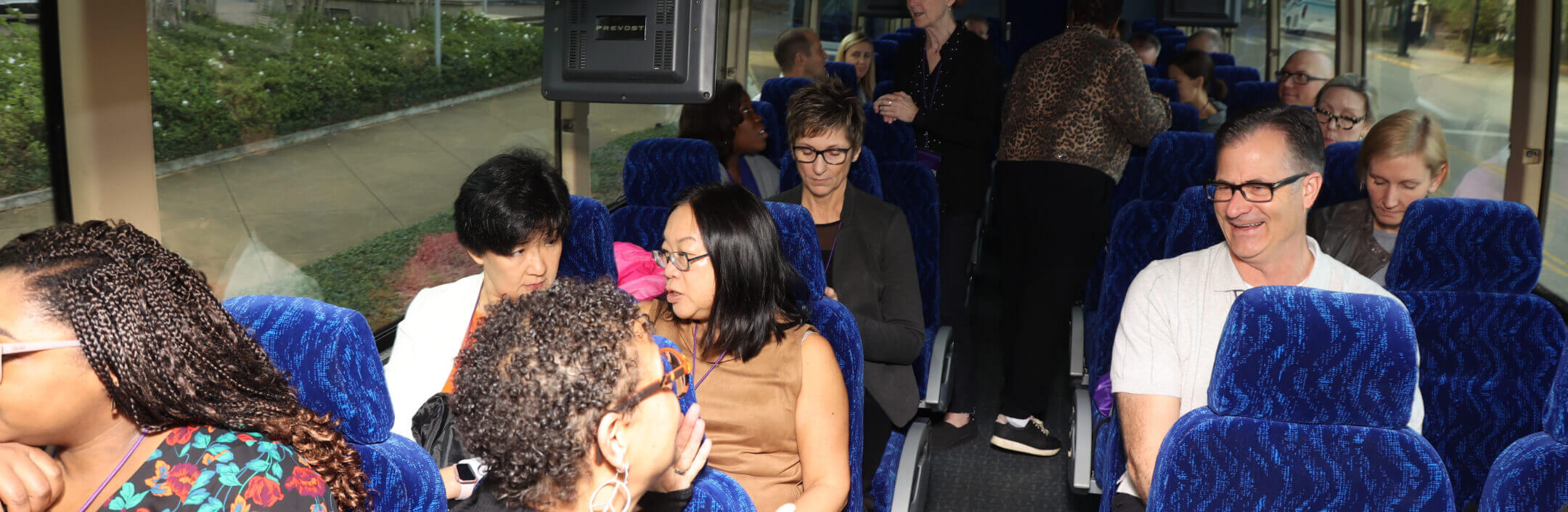 Group of United Properties employees on a coach bus