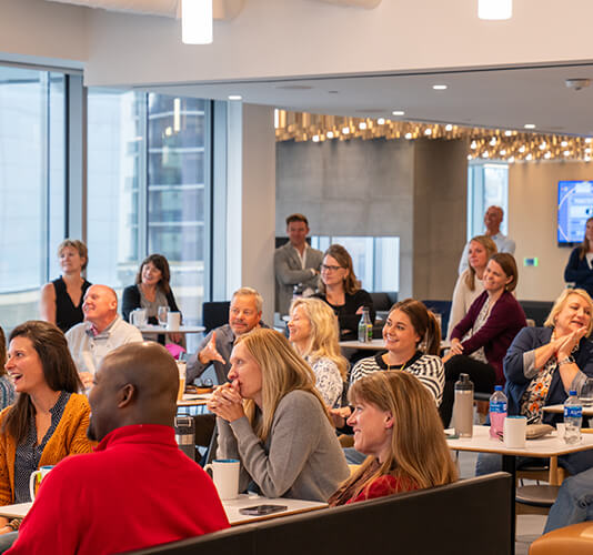 Group of coworkers listening to someone speak